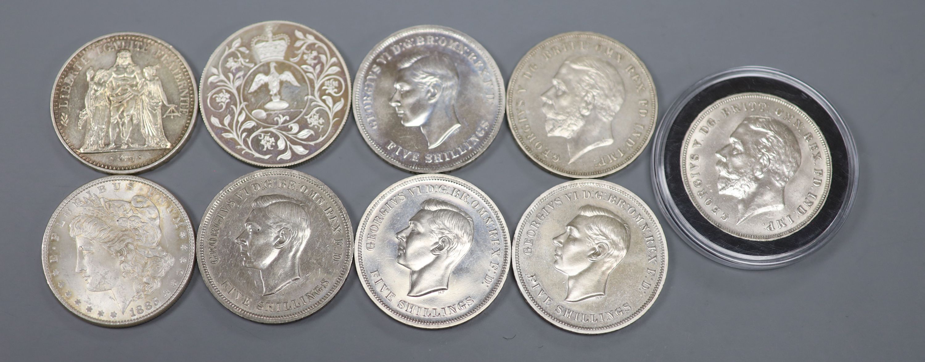 Five 1951 crowns, EF, two 1935 crowns, AEF, a silver 1977 crown, an 1885 Morgan dollar, GVF and a 1965 French Ten Francs, EF